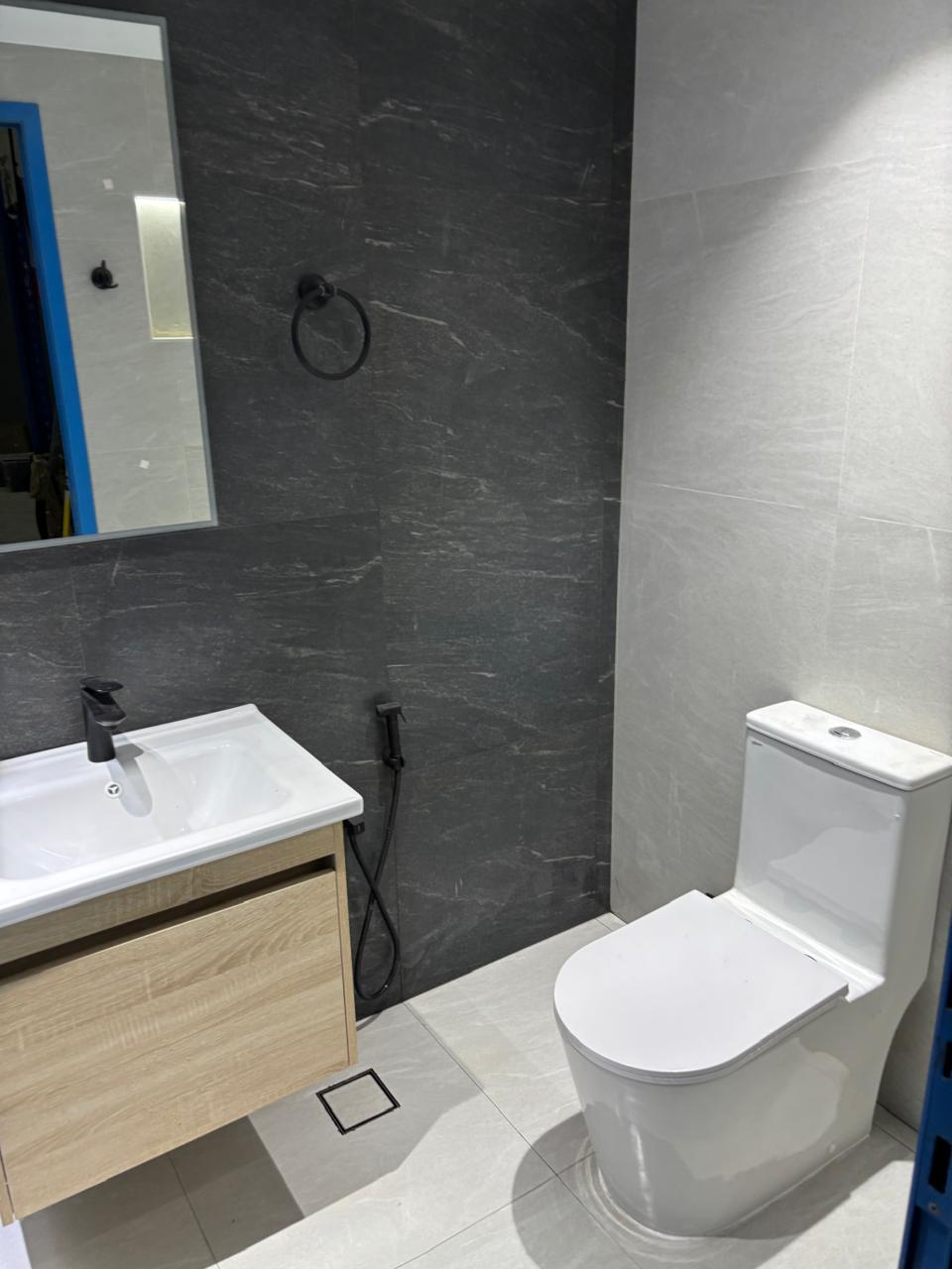 Renovated warehouse bathroom with floating vanity and toilet